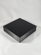 Load image into Gallery viewer, Black square modular organizer base photographed on a white textured background. The flat-topped 3D-printed component features small mounting holes along the sides, showcasing its clean geometric design and compatibility with a customizable modular organizer system.